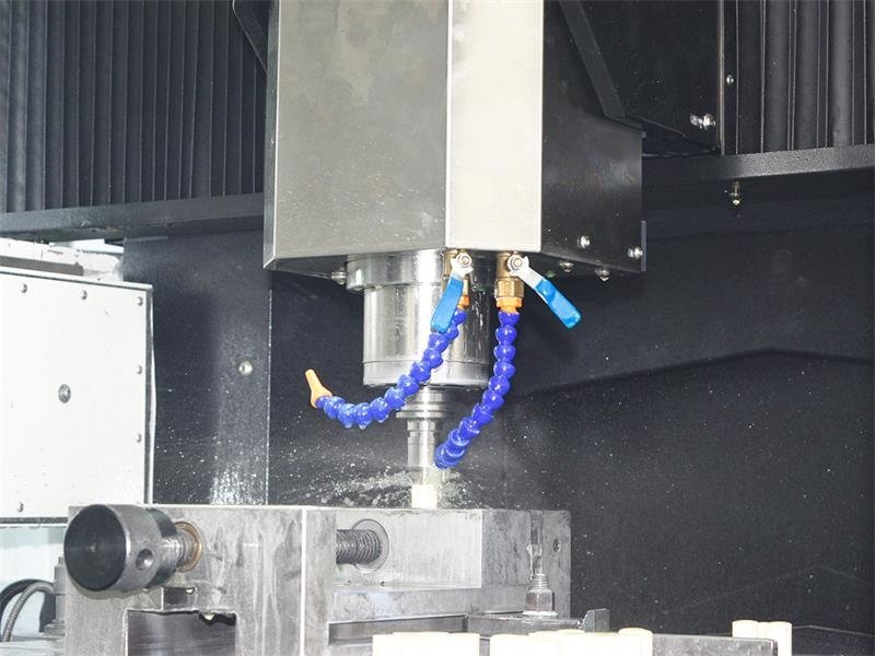 CNC machining spindle with coolant lines cutting a sintered ceramic part